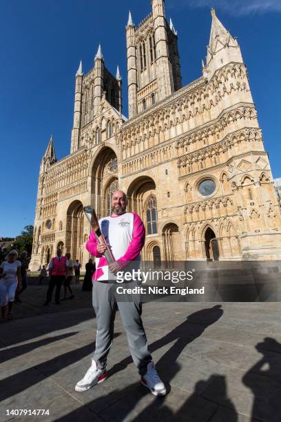 Baton bearer Thomas Draper holds the Queen's Baton during the Birmingham 2022 Queen's Baton Relay on July 10, 2022 in Lincoln, United Kingdom.