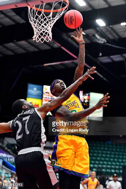 Quincy Miller of the 3 Headed Monsters makes a layup against Jordan Crawford of the Enemies during the game in BIG3 Week Four at Comerica Center on...