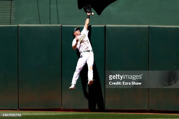 Skye Bolt of the Oakland Athletics can not catch a home run ball hit by Kyle Tucker of the Houston Astros in the eighth inning at RingCentral...