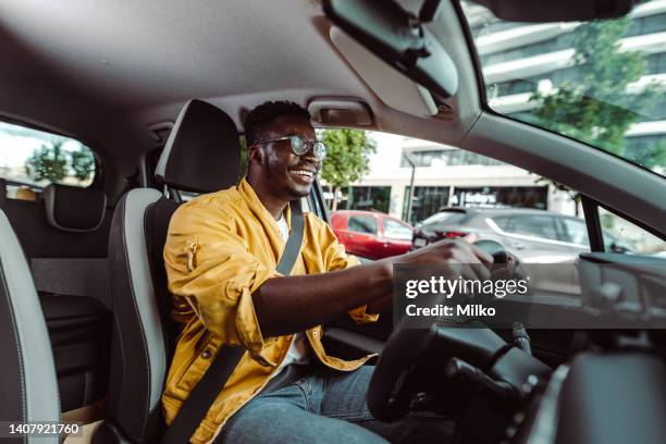 happy african-american male driver in the car - driver seat stock pictures, royalty-free photos & images