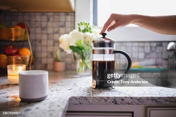 hand pressing plunger on french press coffee maker - woman make up stock pictures, royalty-free photos & images