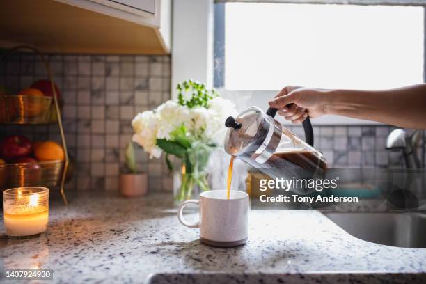 hand pouring coffee from french press coffee maker - coffee plunger stock pictures, royalty-free photos & images