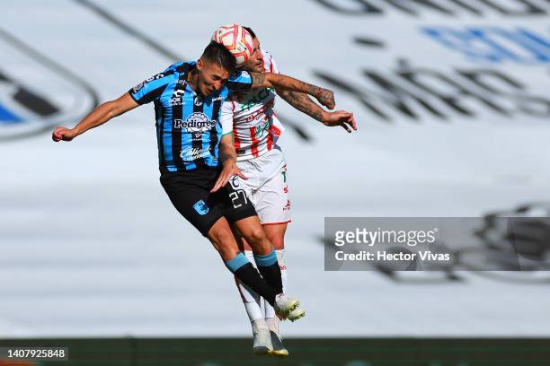 Gabriel Rojas of Queretaro jumps for the ball with Edgar Mendez of Necaxa during the 2nd round match between Queretaro and Necaxa as part of the...
