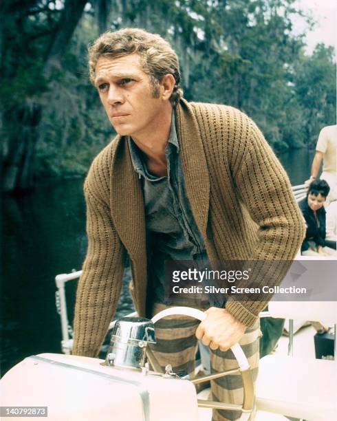 American actor Steve McQueen at the wheel of a boat, circa 1965.