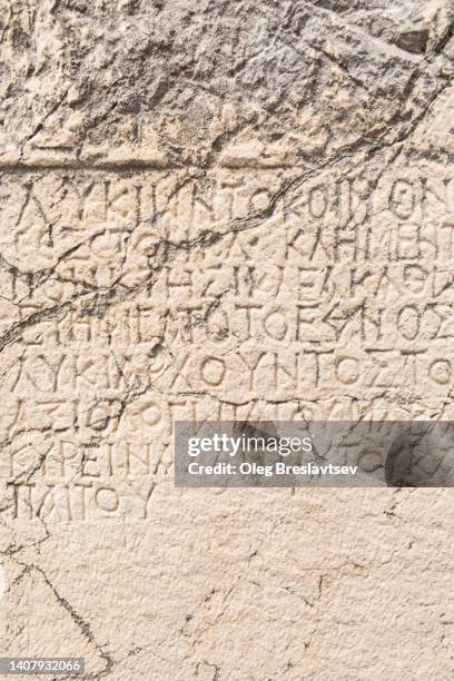 background of old antique stone wall with ancient greek or latin writing. hieroglyph system. lycian culture - medieval background stock pictures, royalty-free photos & images