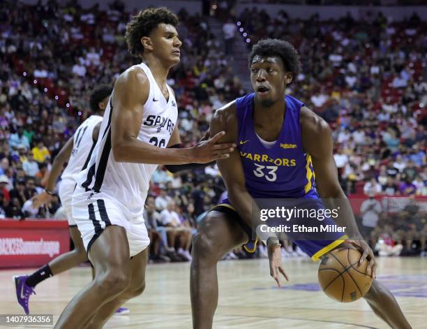 James Wiseman of the Golden State Warriors drives against Dominick Barlow of the San Antonio Spurs during the 2022 NBA Summer League at the Thomas &...