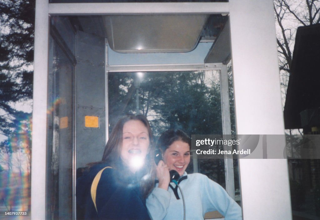 Candid Portrait: Teenagers Having Fun Goofing Around Inside Telephone Booth, 1990s 2000s Y2K, Vintage Friends Having Fun