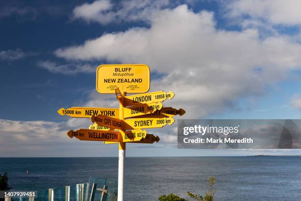 geographical sign at bluff - new zealand icons stock pictures, royalty-free photos & images
