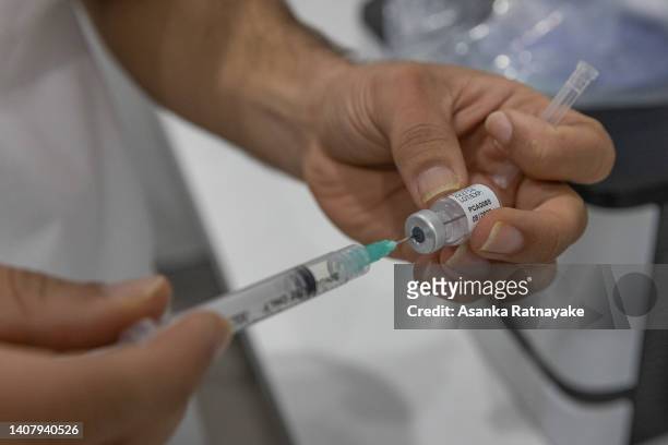 Pharmacist is seen preparing a Covid-19 vaccine at the Pharmacy 4 Less M-City Clayton on July 11, 2022 in Melbourne, Australia. More Australians are...