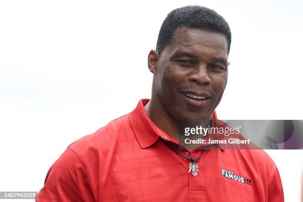 Republican candidate for US Senate Herschel Walker walks onstage during pre-race ceremonies prior to the NASCAR Cup Series Quaker State 400 at...