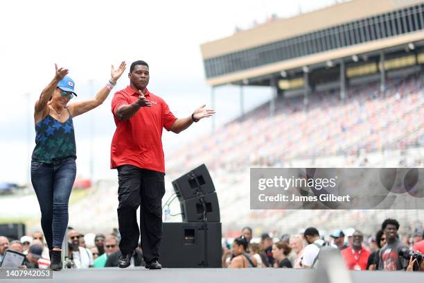 Republican candidate for US Senate Herschel Walker walks onstage during pre-race ceremonies prior to the NASCAR Cup Series Quaker State 400 at...