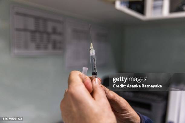 Pharmacist prepares a COVID-19 vaccination booster shot for a customer at the Exhibition Pharmacy on July 11, 2022 in Melbourne, Australia. More...