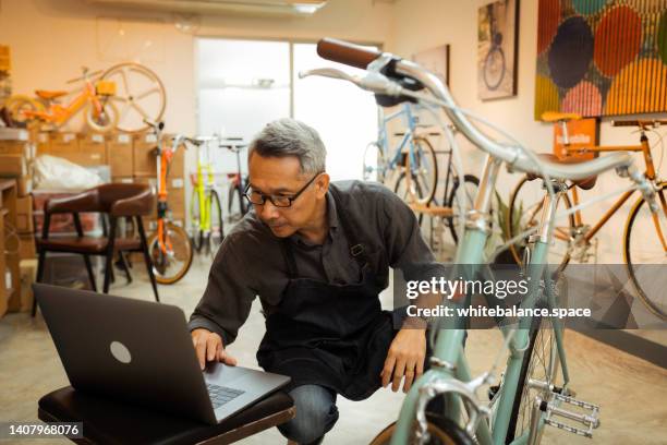 owner of bicycle in his shop. - repair shop stock pictures, royalty-free photos & images