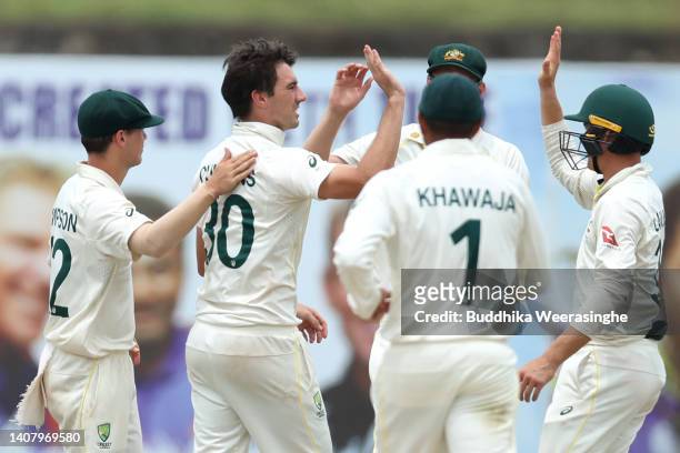Pat Cummins of Australia celebrates with teammates after taking the wicket of Maheesh Theekshana of Sri Lanka during day four of the Second Test in...