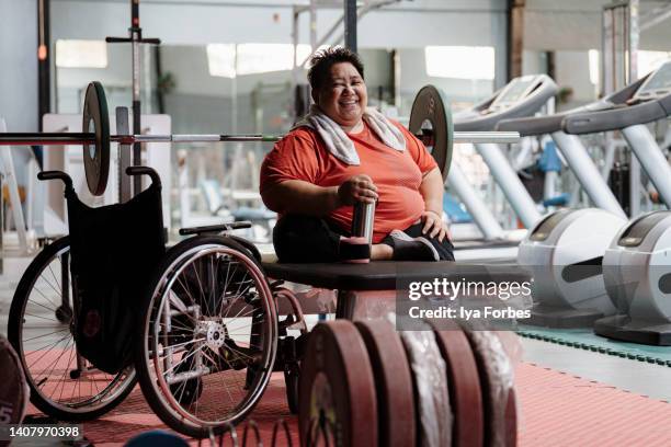 differently abled filipino woman powerlifter smiles to camera after training - disability choicepix stock pictures, royalty-free photos & images