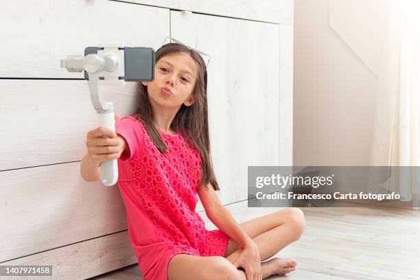 girl making video using smartphone and steady at home - teen girl barefoot at home stock pictures, royalty-free photos & images