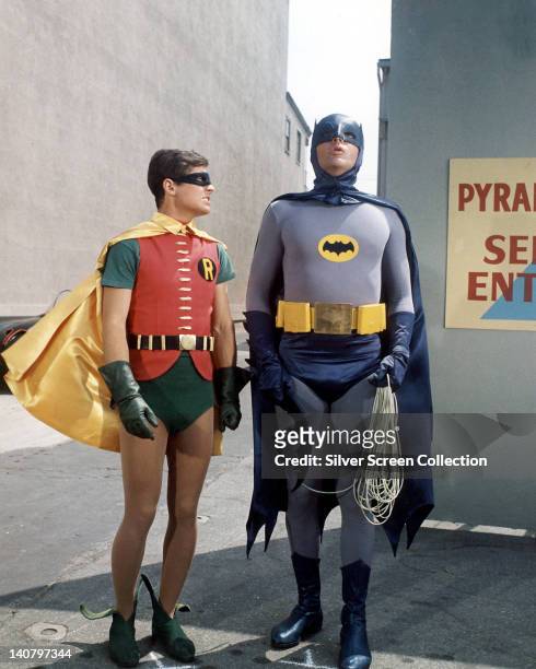 Burt Ward, US actor, and Adam West, US actor, both in costume as the 'Dynamic Duo' in a publicity still issued for the television series, 'Batman',...