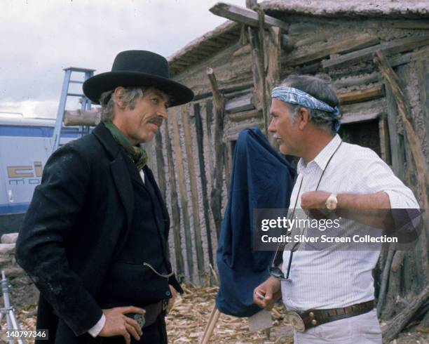 James Coburn , US actor, in costume, and Sam Peckinpah , US film director, on the set of the film, 'Pat Garrett and Billy the Kid', USA, 1973. The...