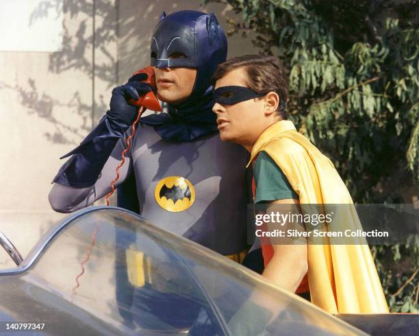 Burt Ward, US actor, and Adam West, US actor, both in costume as the 'Dynamic Duo' in a publicity still issued for the television series, 'Batman',...