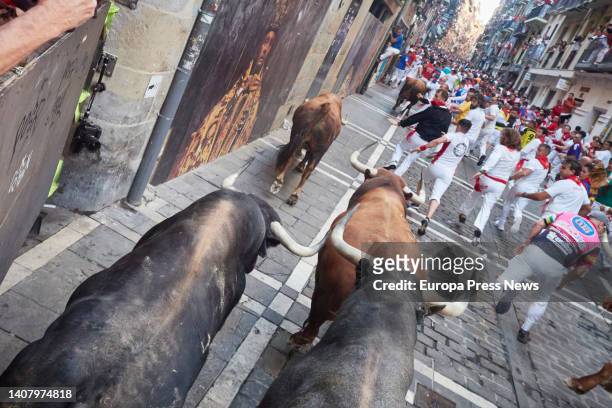 Runners in front of the bulls in the fifth running of the bulls of the Fiestas de San Fermin 2022 of the Don Jose Cebada Gago ranch, on July 11 in...