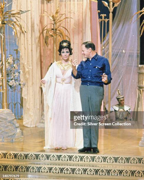 Elizabeth Taylor , British actress, in costume, and Joseph L Mankiewicz , US film director, on the set of the film, 'Cleopatra', 1963. The historical...