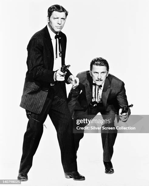 Burt Lancaster , US actor, and Kirk Douglas, US actor, both in costume and holding pistols in a publicity portrait issued for the film, 'Gunfight at...