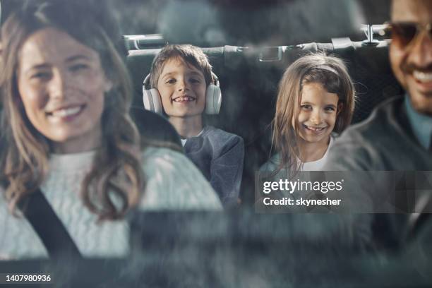 happy kids enjoying while going on family vacation by car. - girls driving a car stock pictures, royalty-free photos & images