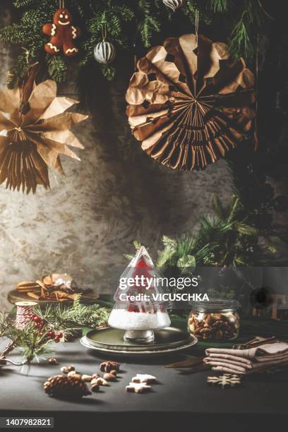 christmas still life with seasonal handmade decoration on dark table with brown wall background - christmas still life fotografías e imágenes de stock