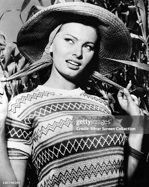 Sophia Loren, Italian actress, wearing a short-sleeve jumper and a wide-brim straw hat, circa 1955.