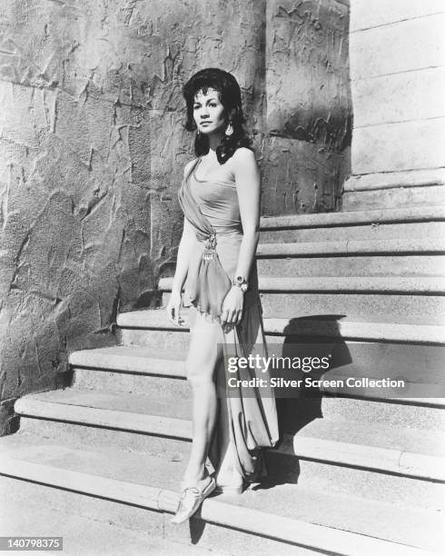 Full length portrait of Barbara Luna, US actress, in costume as she descends a staircase, circa 1960.