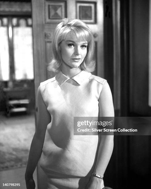 Carol Lynley, US actress, wearing a sleeveless white dress in a studio portrait, circa 1965.