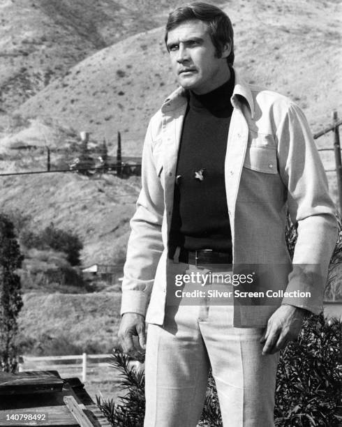 Lee Majors, US actor, wearing a white denim suit, with a black polo neck jumper, in a publicity portrait issued for the US television series, 'The...