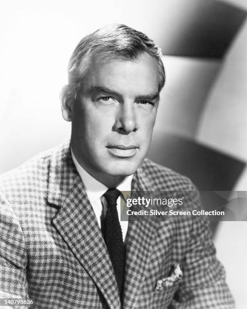 Lee Marvin , US actor, wearing a tweed jacket over a white shirt and a black tie, in a studio portrait, circa 1965.