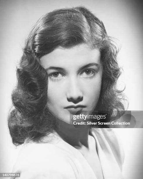Headshot of Zena Marshall , British actress, with a forties hairstyle in a studio portrait, against a white background, circa 1950.