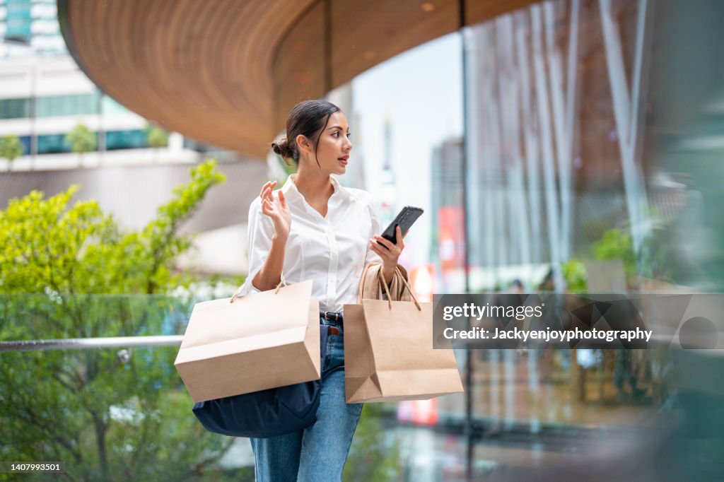 Portrait of a wealthy asian woman outside a luxury mall