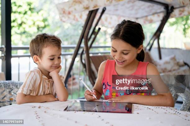 happy children using digital tablet outdoors - boy using ipad imagens e fotografias de stock