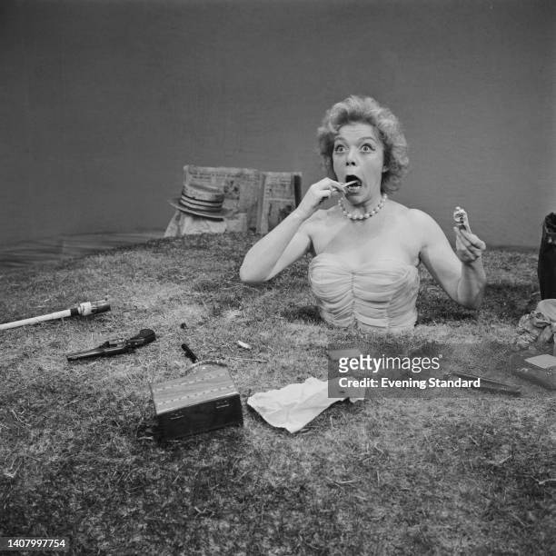 British actress Brenda Bruce partially buried in a scene from 'Happy Days' at the Royal Court Theatre, London, England, 30th December 1962. Bruce is...