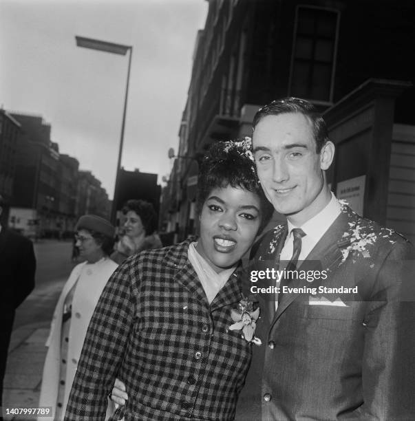 American singer Joy Marshall and British saxophonist Peter King 1940-2020) on their wedding day outside Westminster Register Office at Marylebone...