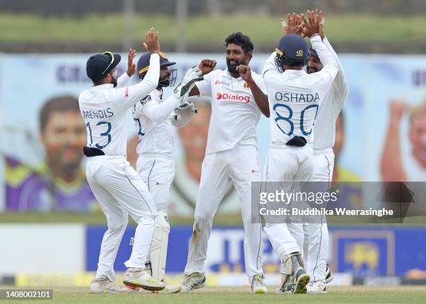 Prabath Jayasuriya of Sri Lanka celebrates with teammates after taking the wicket Usman Khawaja of Australia during day four of the Second Test in...