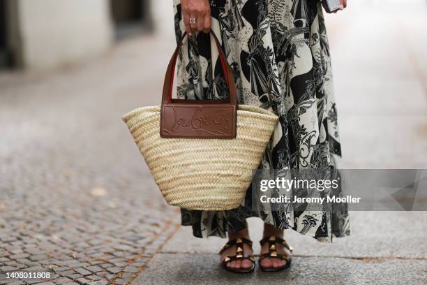 Yasmin von Schlieffen-Nannen seen wearing a black/white paisley pattern long dress, a bast basket Louboutin shopper bag and black leather stud...