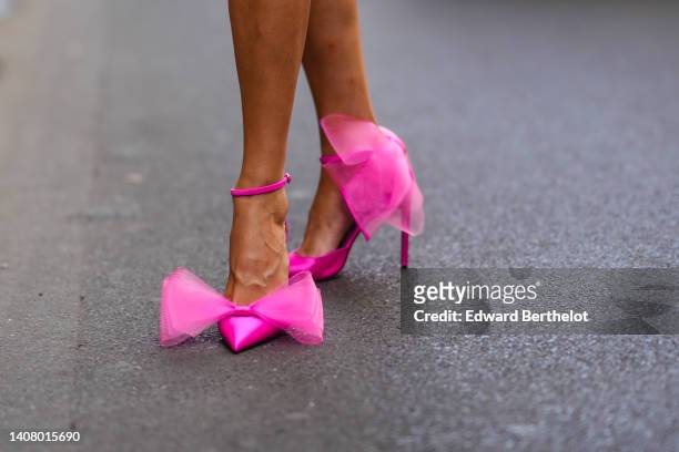 Marta Sierra wears neon pink shiny satin pointed pumps heels shoes with embroidered tulle knot ankle , outside Viktor & Rolf, during Paris Fashion...