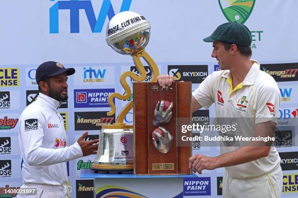 Pat Cummins of Australian caption, right, holds Warne-Muralidaran trophy as Dimuth Karunaratne of Sri Lankan caption while trophy presentation...