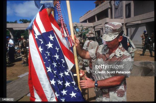 Soldier handles the American flag May 4, 1993 in Mogadishu, Somalia. Following the departure of US forces, UN troops will continue the humanitarian...