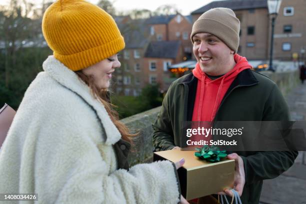 handing over gifts - christmas gift exchange stock pictures, royalty-free photos & images