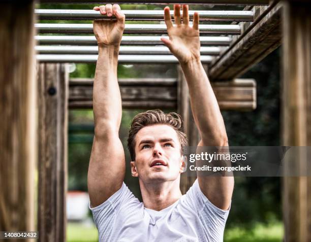 training on monkey bars in the park - monkey bars stock pictures, royalty-free photos & images