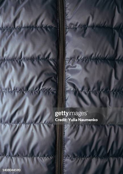 puffer jacket texture. down jacket fabric background. background of urban winter outfit. - padded jacket - fotografias e filmes do acervo