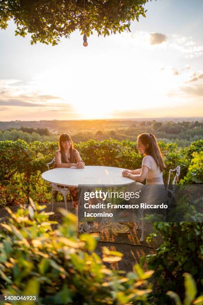 women friends having fun at sunset - tuscany villa stock-fotos und bilder