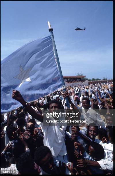 Protesters wave the national flag June 14, 1993 in Mogadishu, Somalia. Tensions continue to rise as Somali-faction leader General Aidid calls the...