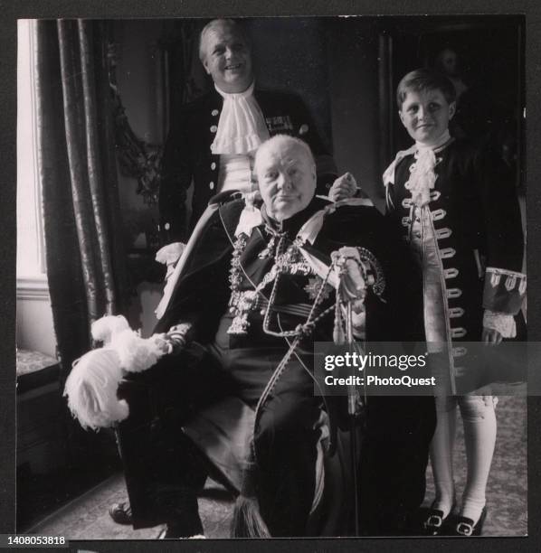 Portrait of British Prime Minister Winston Churchill as he poses with his son, former politician Randolph Churchill , and grandson, future politician...