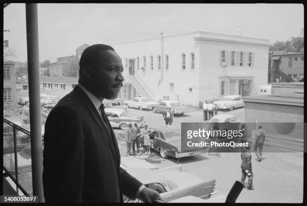 View of American Religious and Civil Rights leader Dr Martin Luther King Jr as he stands on a balcony at the AG Gaston Motel during the Southern...